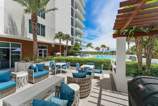 view of patio with a balcony, a pergola, outdoor lounge area, and a community pool