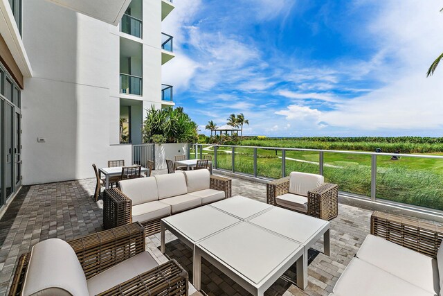 view of patio with a balcony and outdoor lounge area