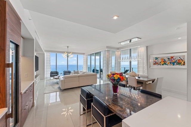 kitchen with a notable chandelier, light tile patterned flooring, and expansive windows