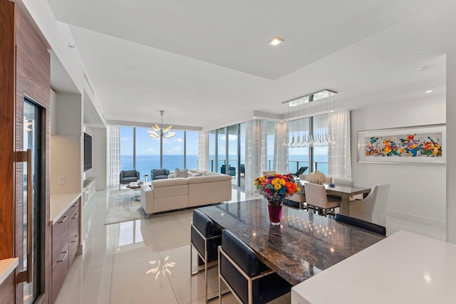 5000 N Ocean Dr Unit 1003, Singer Island, FL 33404 - dining area featuring a chandelier, light tile patterned flooring, and expansive windows