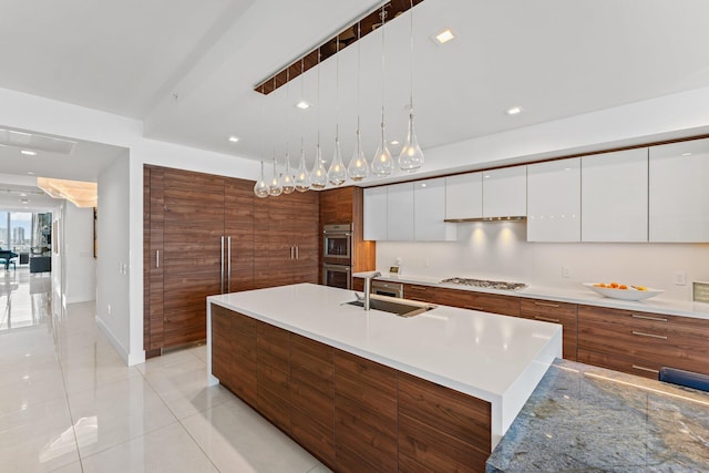 5000 N Ocean Dr Unit 1003, Singer Island, FL 33404 - kitchen with a sink, modern cabinets, stainless steel appliances, white cabinetry, and light tile patterned floors