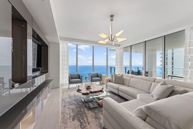 tiled living room featuring an inviting chandelier, a wall of windows, and a healthy amount of sunlight