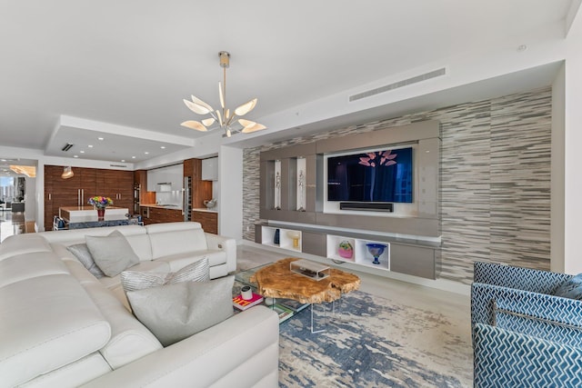 living room with tile walls and a chandelier