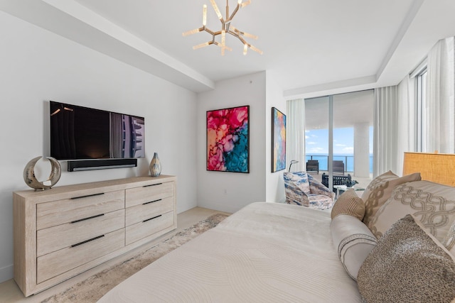 bedroom featuring an inviting chandelier and access to exterior