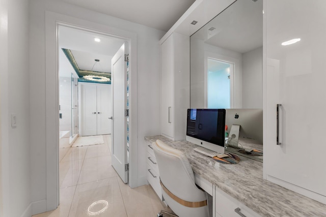 5000 N Ocean Dr Unit 1003, Singer Island, FL 33404 - office area featuring built in desk, light tile patterned floors, and baseboards