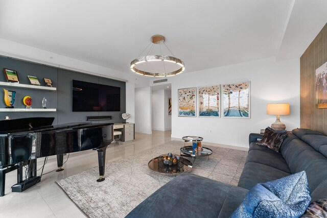 tiled living room with a notable chandelier