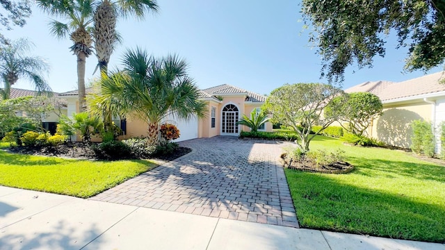 mediterranean / spanish home with a front yard