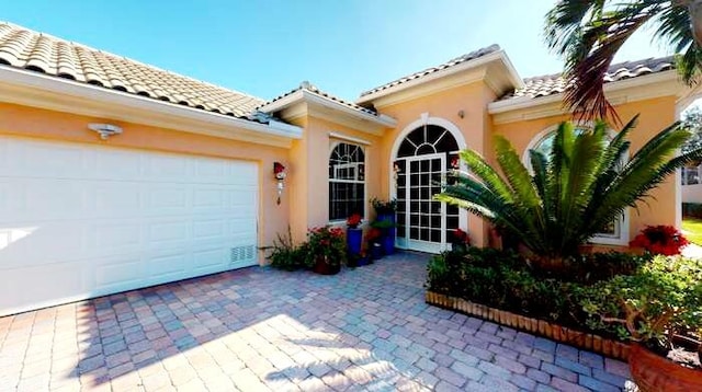 mediterranean / spanish-style house with a garage