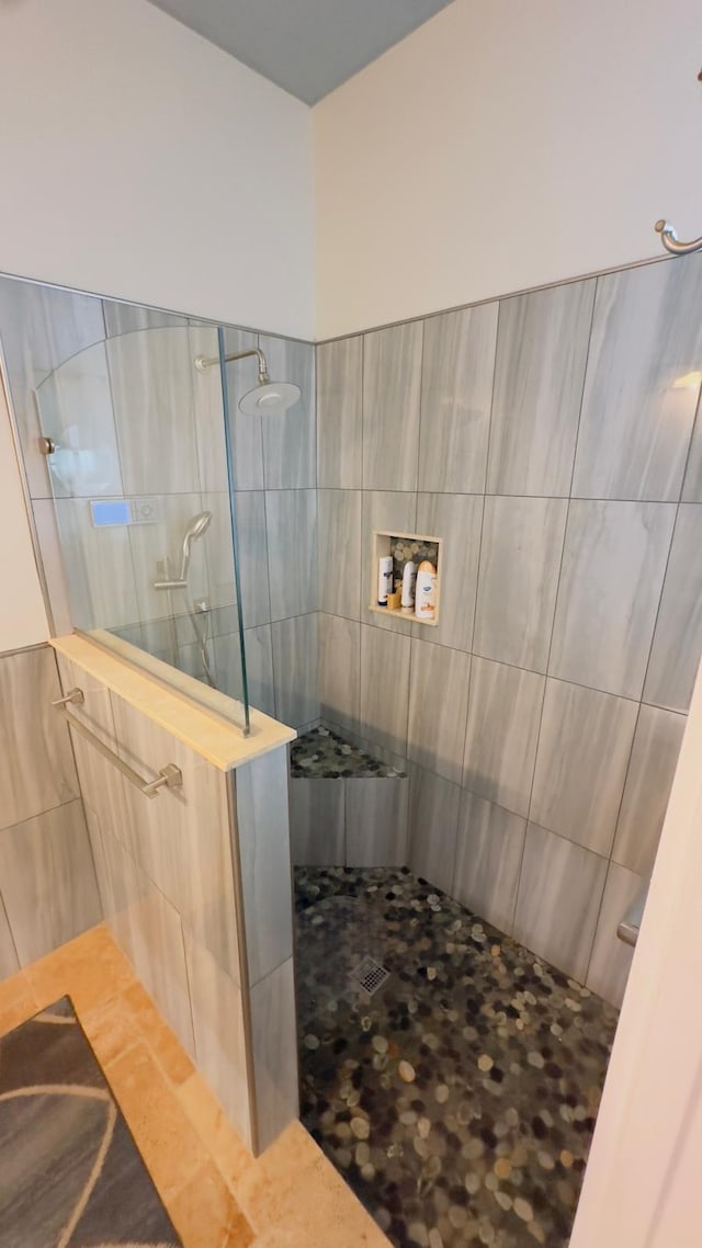 bathroom with tiled shower