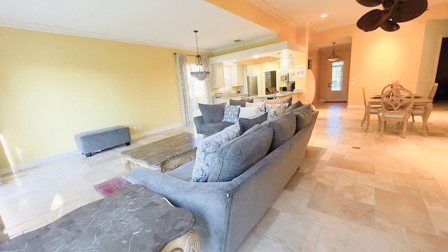 living room featuring ceiling fan and ornamental molding