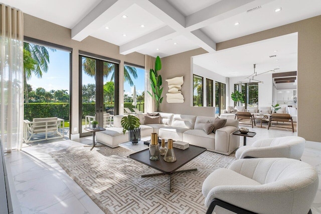 living room featuring beamed ceiling and french doors