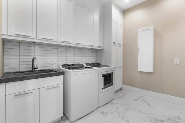 laundry area featuring cabinets, sink, and washer and dryer