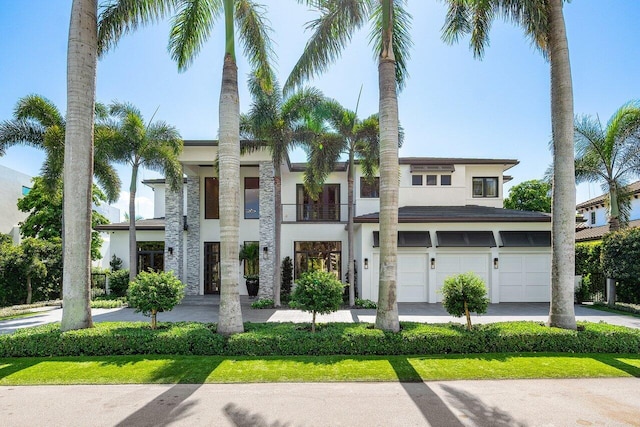 view of front of home with a balcony and a garage