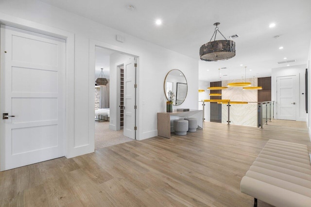 hall with light hardwood / wood-style floors