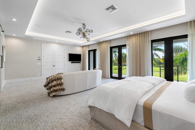 carpeted bedroom with ceiling fan, a raised ceiling, a closet, french doors, and access to outside