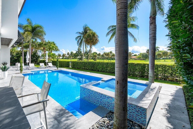 view of swimming pool with a patio area and an in ground hot tub