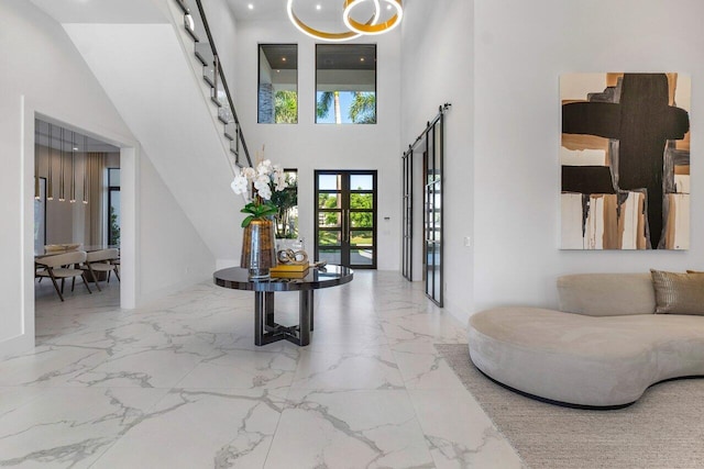 foyer entrance featuring a high ceiling and french doors