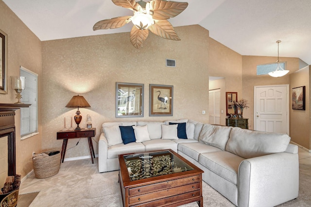 carpeted living room featuring ceiling fan and lofted ceiling