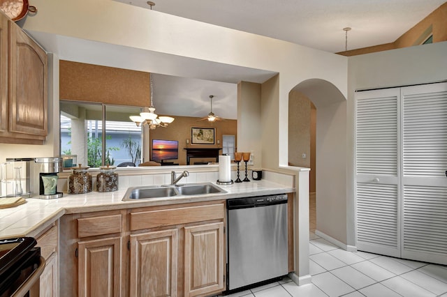 kitchen with dishwasher, light tile patterned flooring, sink, light brown cabinets, and decorative light fixtures