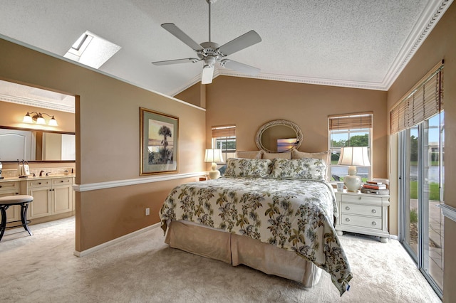 carpeted bedroom with access to exterior, a textured ceiling, ceiling fan, a skylight, and ornamental molding