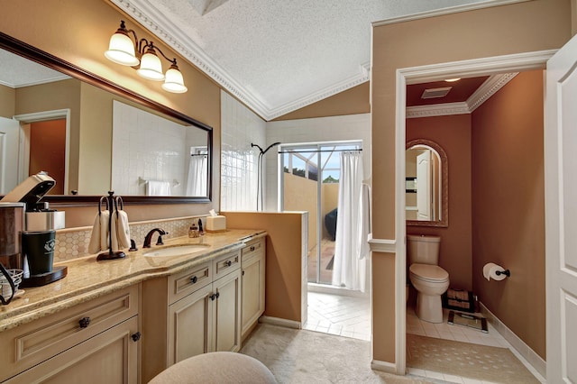 bathroom with vaulted ceiling, vanity, a textured ceiling, crown molding, and toilet