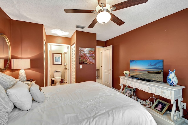 bedroom with ceiling fan, a textured ceiling, and ensuite bathroom