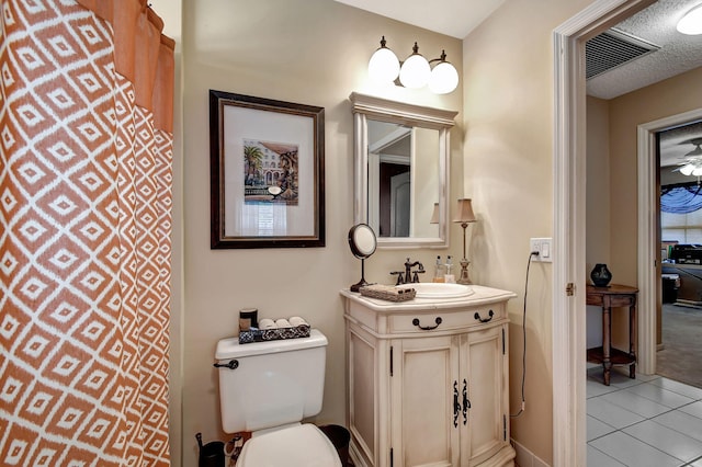 bathroom with tile patterned floors, ceiling fan, vanity, and toilet