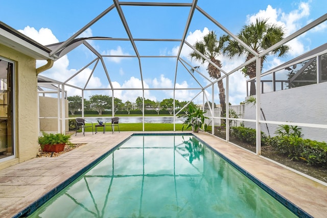 view of swimming pool with a water view, a patio, and glass enclosure