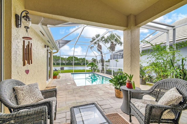 view of swimming pool featuring a lanai and a patio area