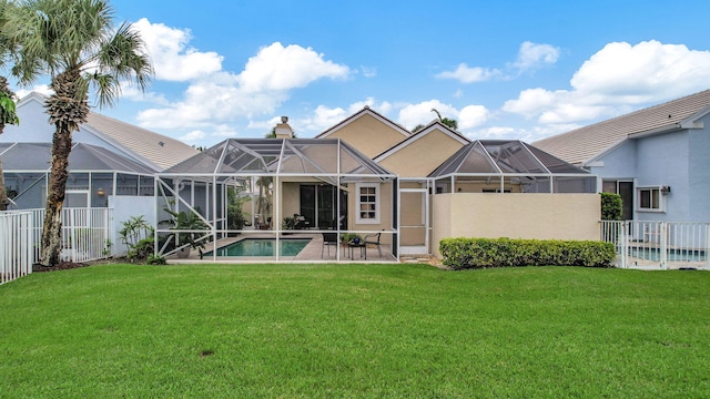 back of property featuring a yard, a lanai, and a fenced in pool