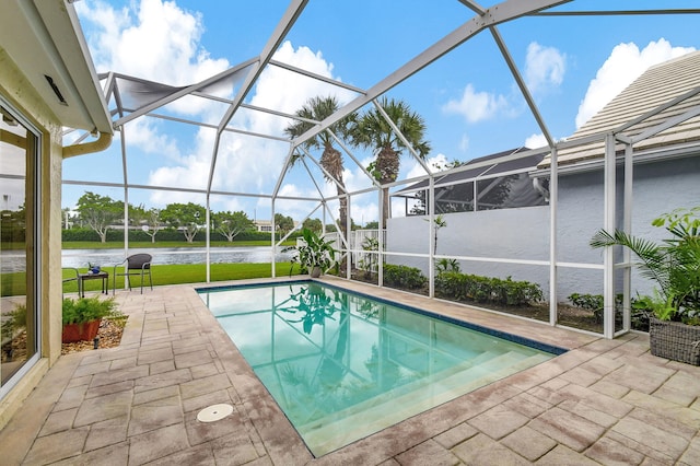 view of swimming pool featuring glass enclosure, a water view, and a patio area