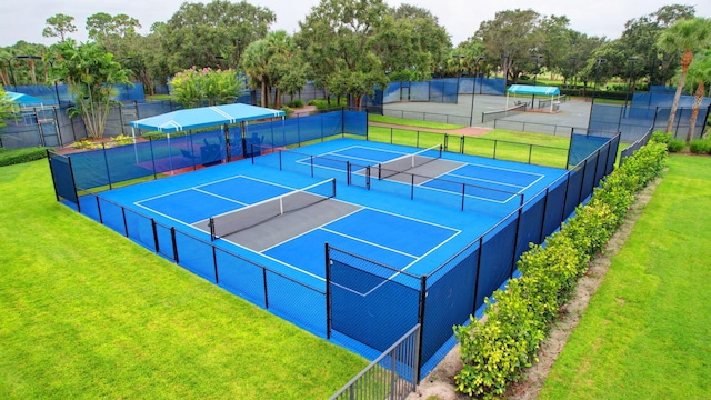 view of sport court featuring a lawn