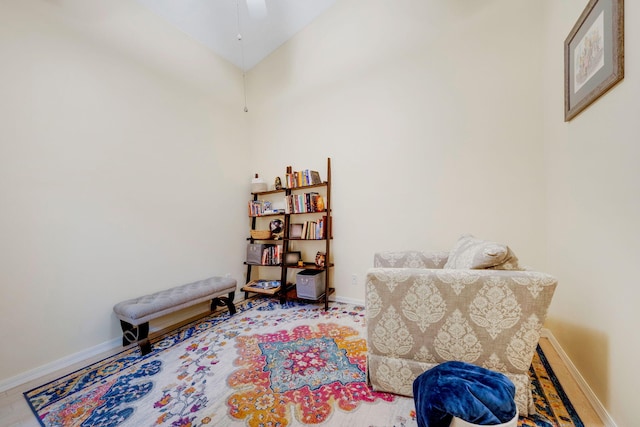 living area featuring vaulted ceiling and ceiling fan