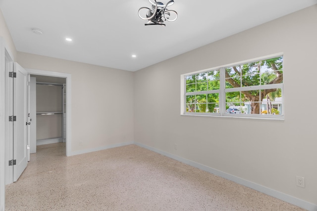 unfurnished bedroom featuring a spacious closet and a closet