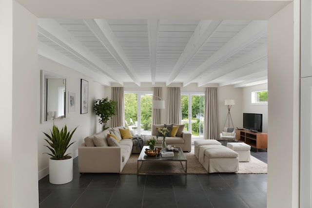 living room featuring dark tile patterned flooring and beam ceiling