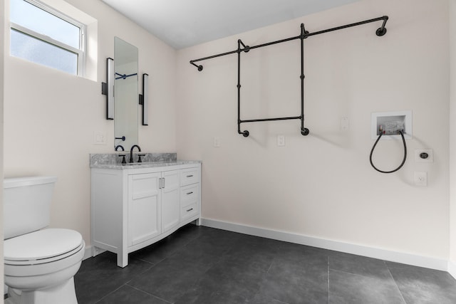 bathroom featuring vanity, tile patterned flooring, and toilet