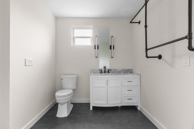 bathroom featuring vanity, toilet, and tile patterned floors