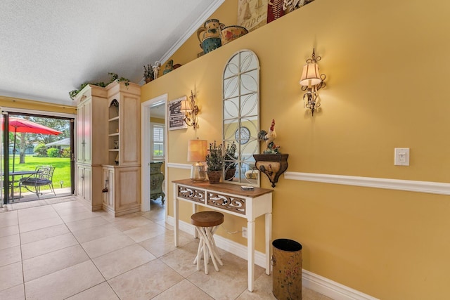 interior space featuring light tile patterned floors, a textured ceiling, vaulted ceiling, and ornamental molding