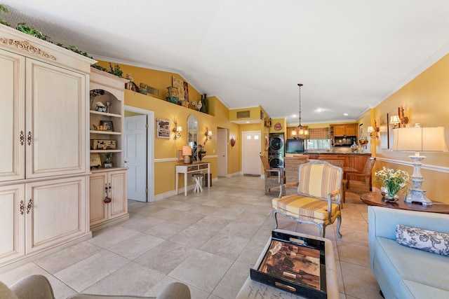 tiled living room featuring stacked washing maching and dryer, ornamental molding, and vaulted ceiling