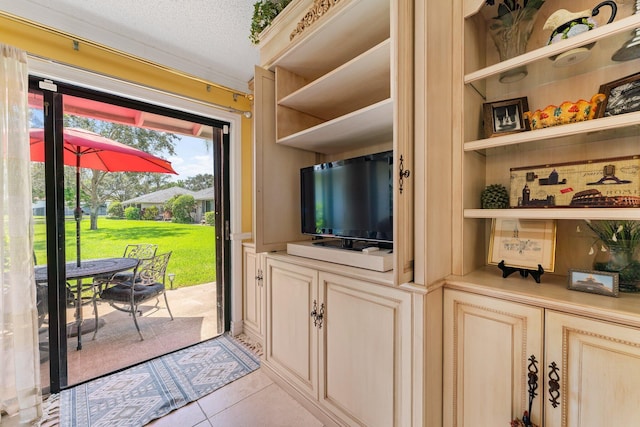 119 Club Dr, Palm Beach Gardens, FL 33418 - doorway to outside featuring built in shelves, a textured ceiling, and light tile patterned flooring