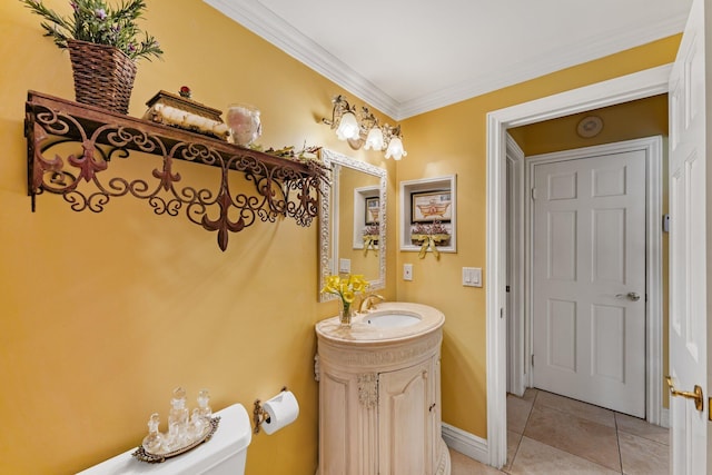 bathroom featuring tile patterned floors, crown molding, vanity, and toilet