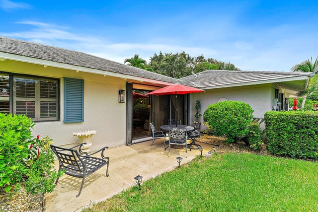 back of house featuring a patio and a lawn