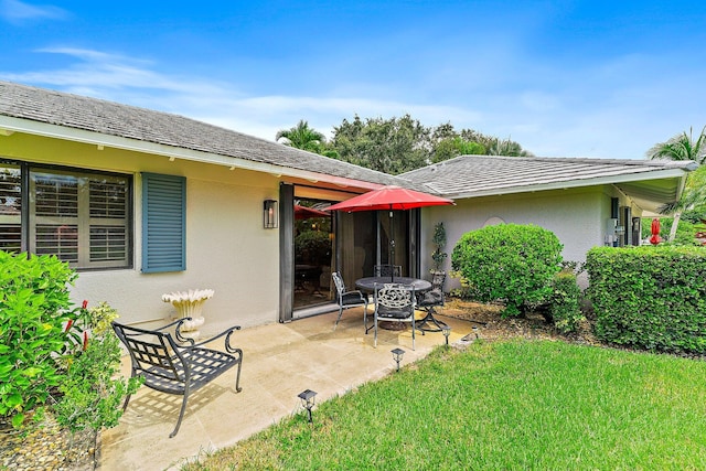 119 Club Dr, Palm Beach Gardens, FL 33418 - back of property with stucco siding, a patio, and a lawn