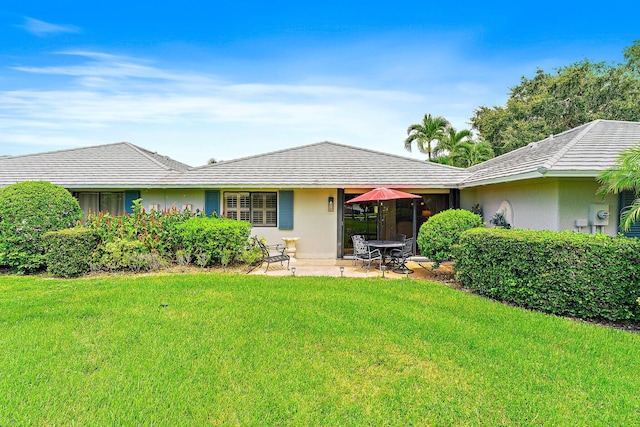 ranch-style house with a front lawn and a patio area