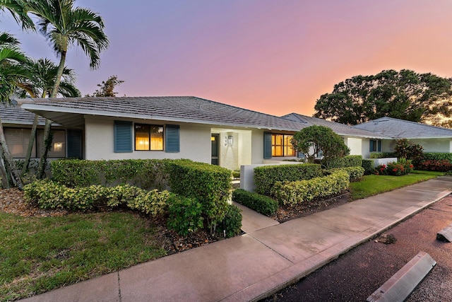 119 Club Dr, Palm Beach Gardens, FL 33418 - ranch-style house with a lawn and stucco siding