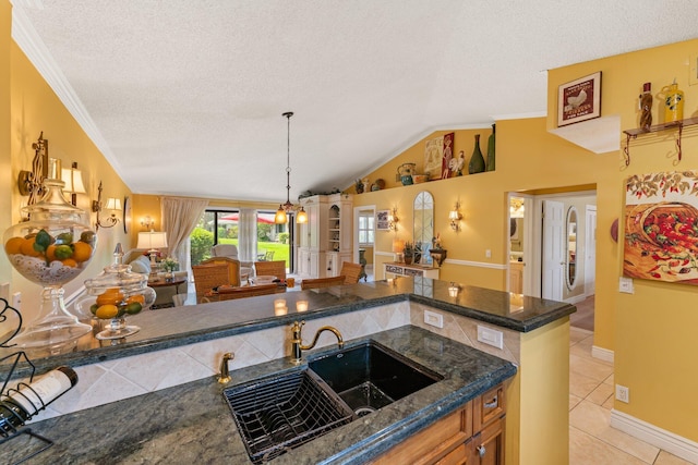 119 Club Dr, Palm Beach Gardens, FL 33418 - kitchen featuring light tile patterned floors, a sink, vaulted ceiling, a textured ceiling, and open floor plan