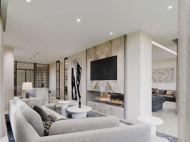 living room with a large fireplace and expansive windows