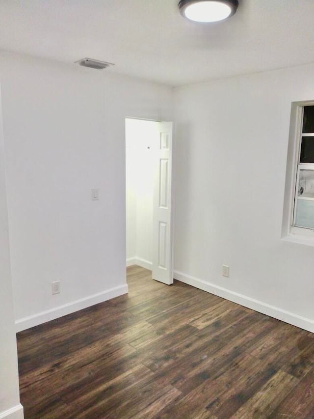 empty room with dark wood-type flooring