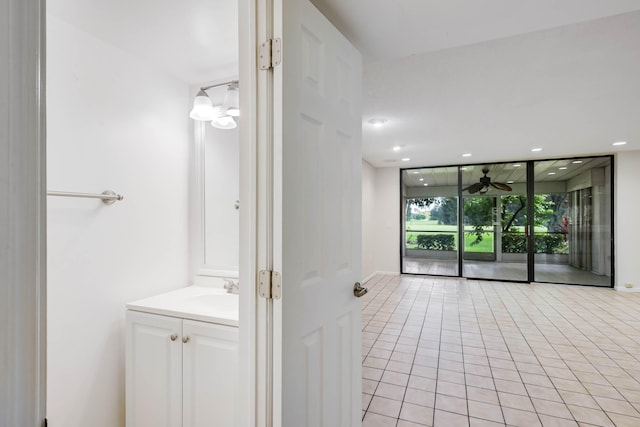 bathroom featuring tile patterned floors, vanity, and expansive windows