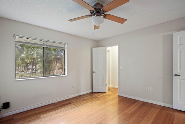 interior space with light hardwood / wood-style floors, ceiling fan, and a textured ceiling